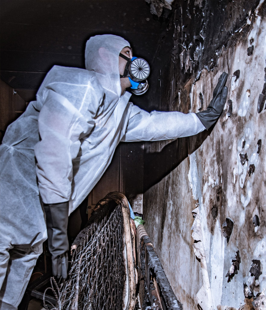 Technician inspecting a fire-damaged property